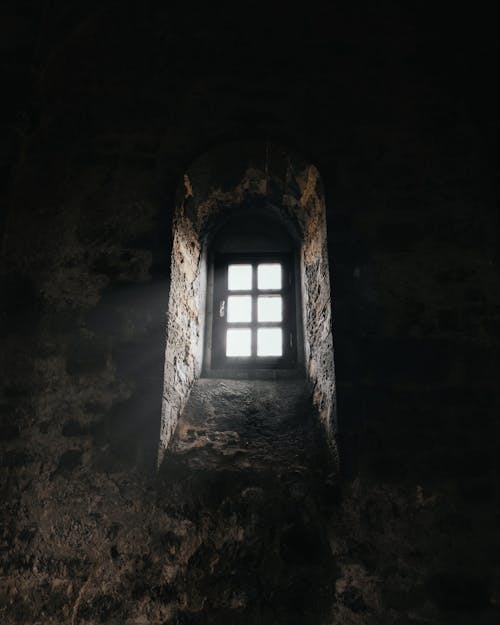 A window in an old building with sunlight coming through