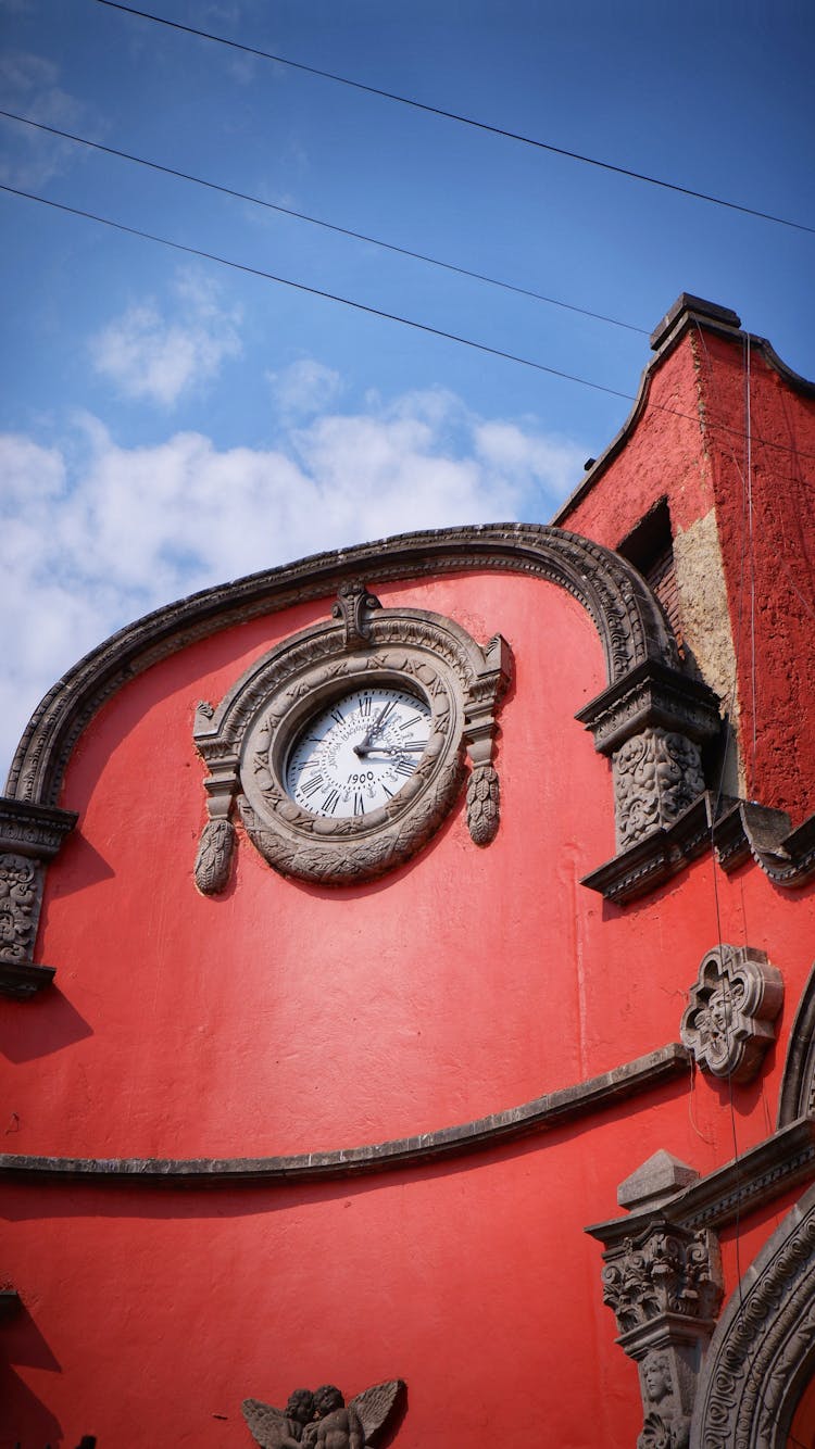 A Red Building With A Clock 