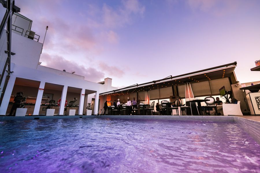 Resort-style pool glowing at sunset