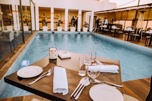 Brown Wooden Table Beside Pool