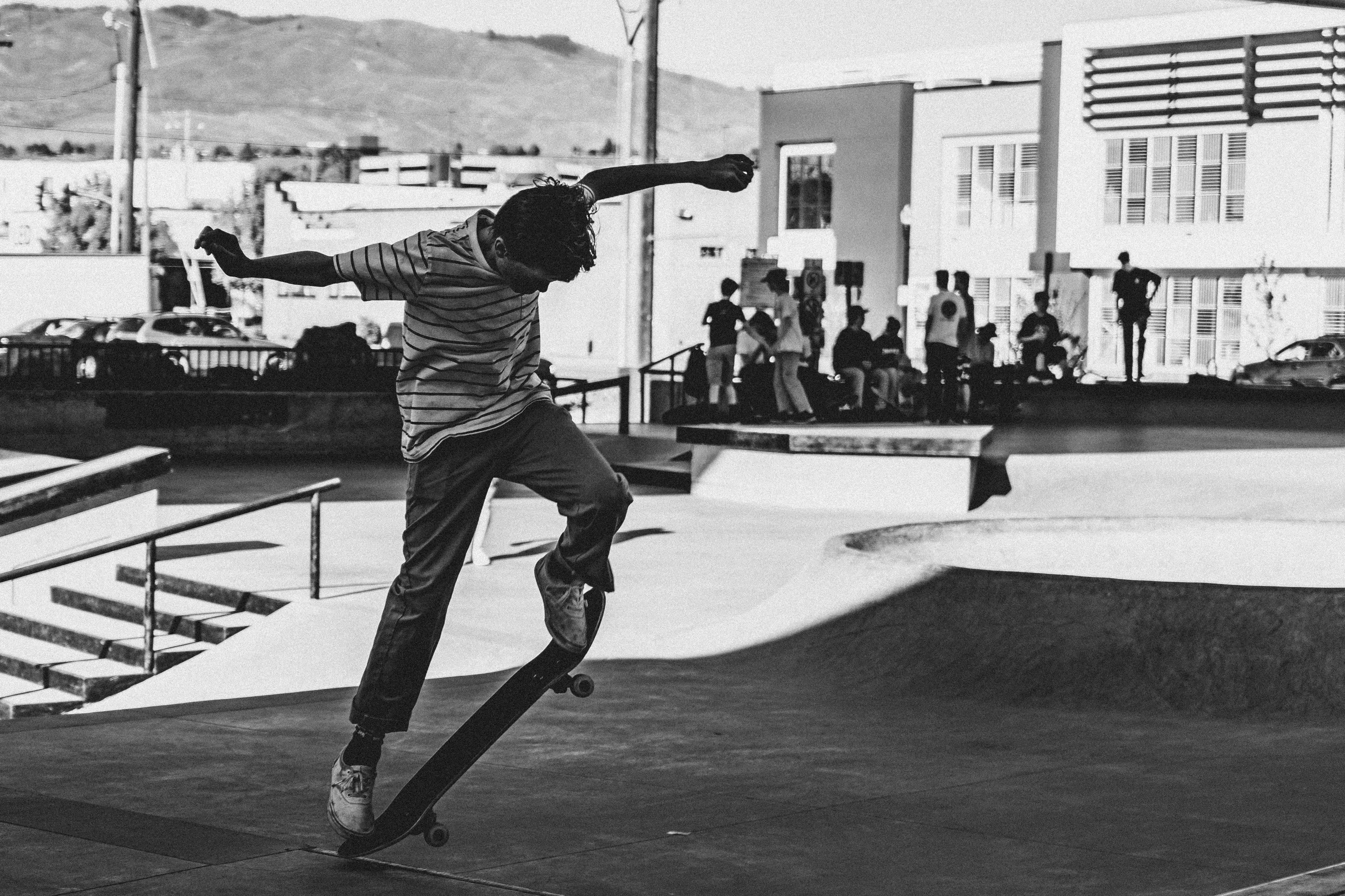 grayscale photography of man skateboarding