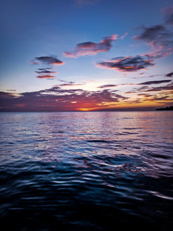 Cumulus Clouds Above Ocean during Golden Hour