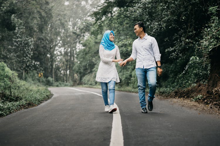 Man And Woman Walking On Road