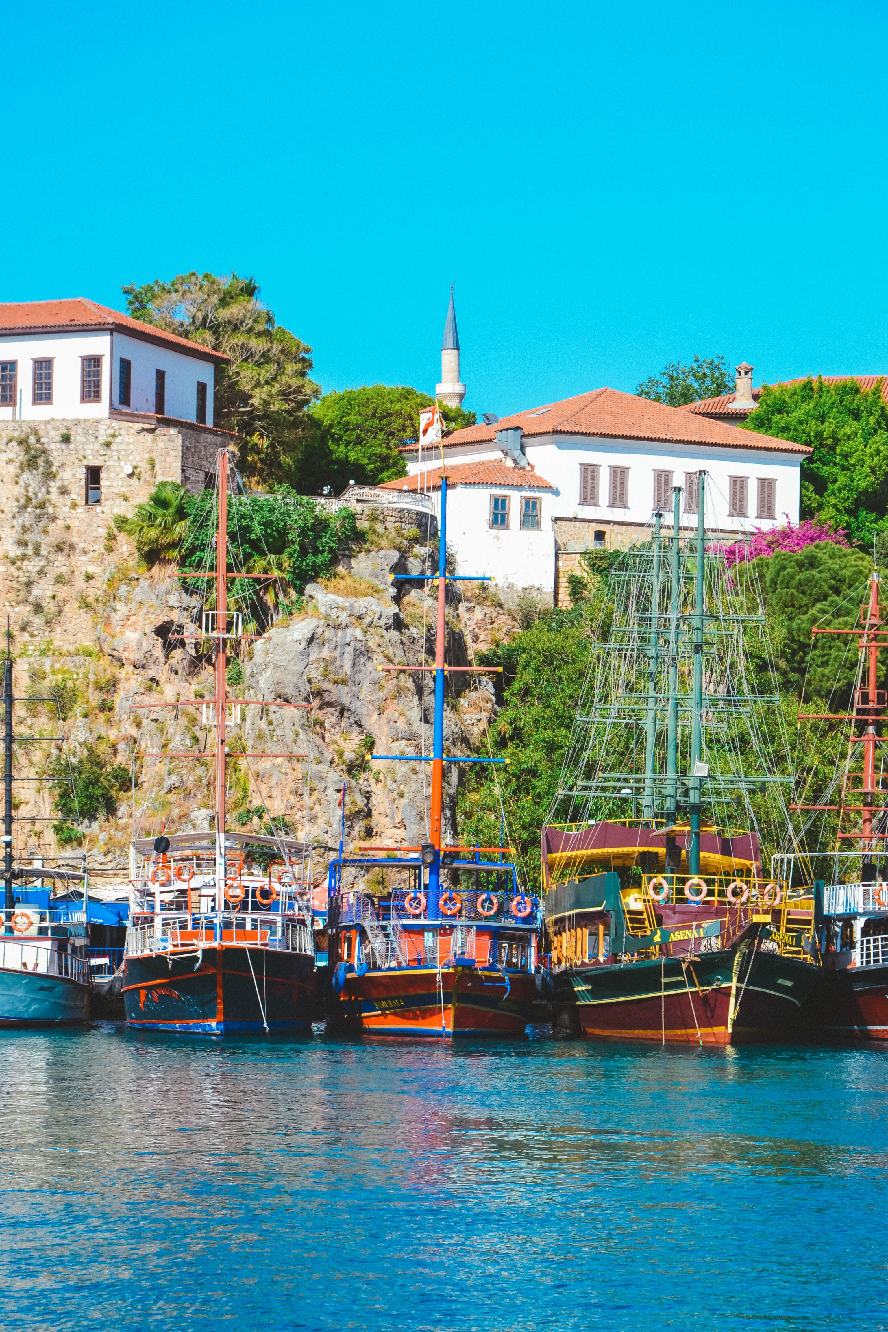 Boats docked in the harbor of a small town · Free Stock Photo
