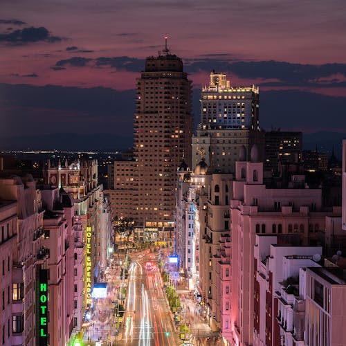 Buildings around Illuminated Street in Madrid at Night