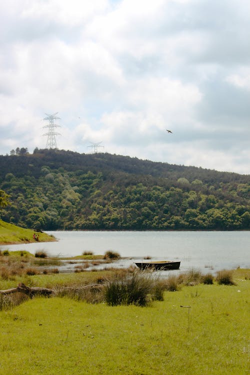 A large body of water with a large hill in the background