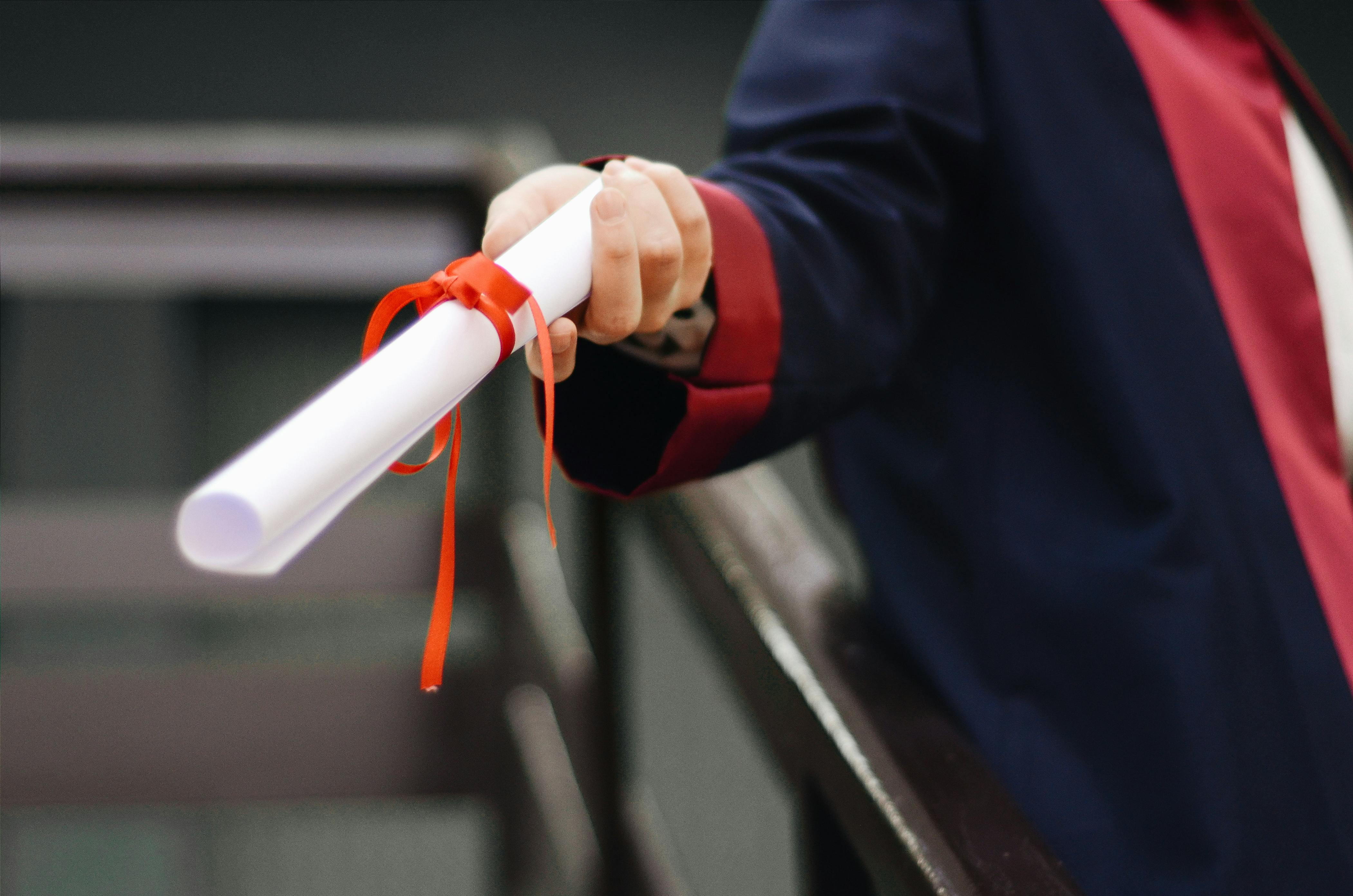 A person handing a rolled paper