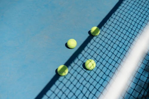 Tennis Balls behind Net
