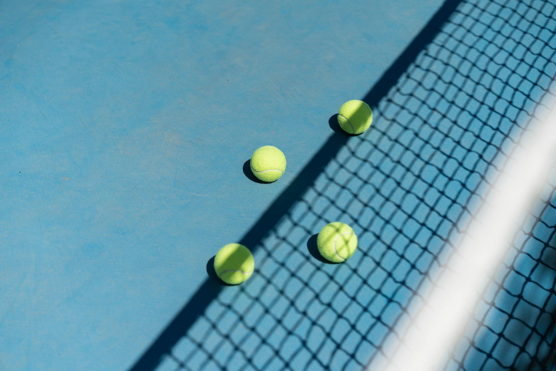 Tennis Balls behind Net