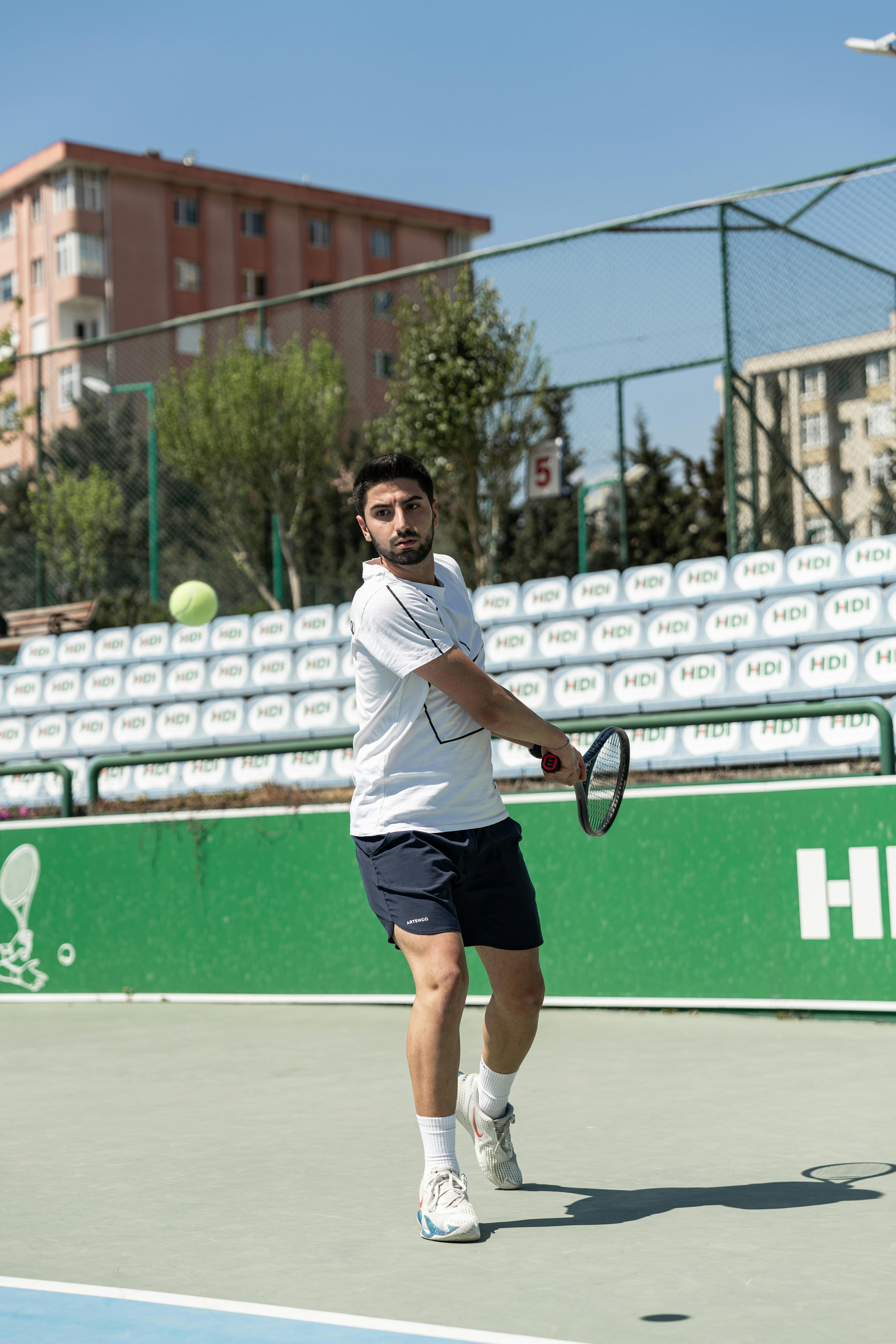 man hitting tennis ball