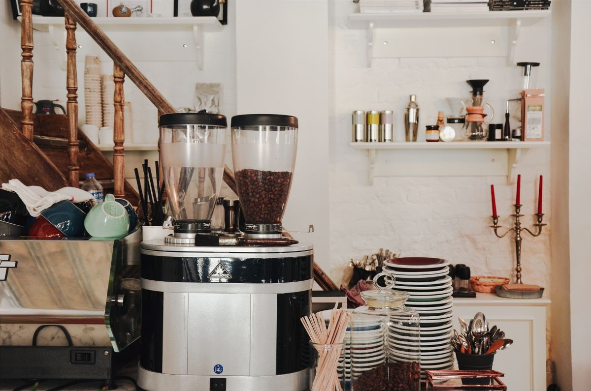 Coffee grinder in a cafe interior, for illustration