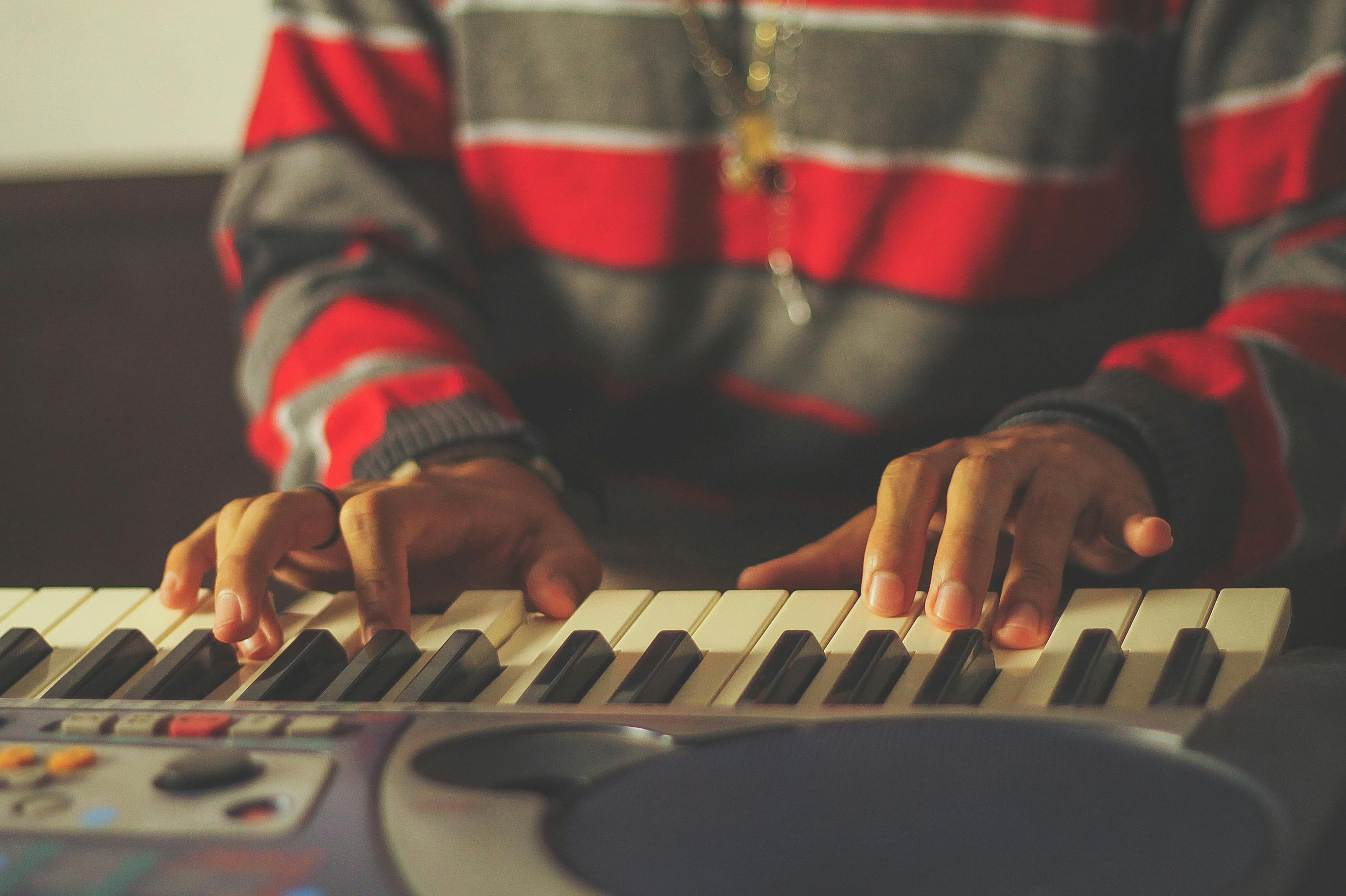 Close-Up Photo of Person Playing Piano · Free Stock Photo