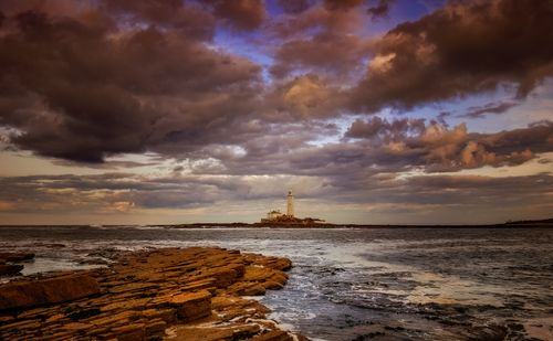 Free Capture of St Mary's Lighthouse against a dramatic sunset sky in Whitley Bay, England. Stock Photo