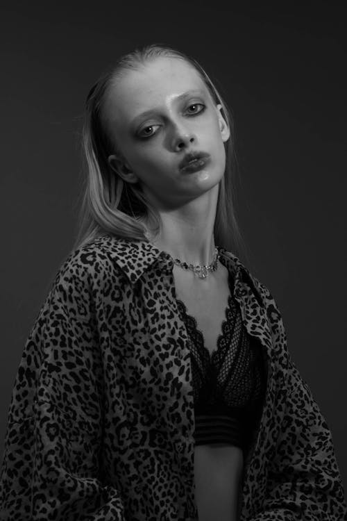A woman in a leopard print jacket and black and white photo