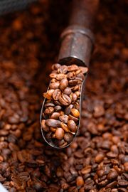 Metal scoop filled with roasted coffee beans — photo by Tallita Maynara on Pexels
