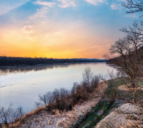 Free Serene winter sunset over a frozen river in Ella, Wisconsin. Stock Photo