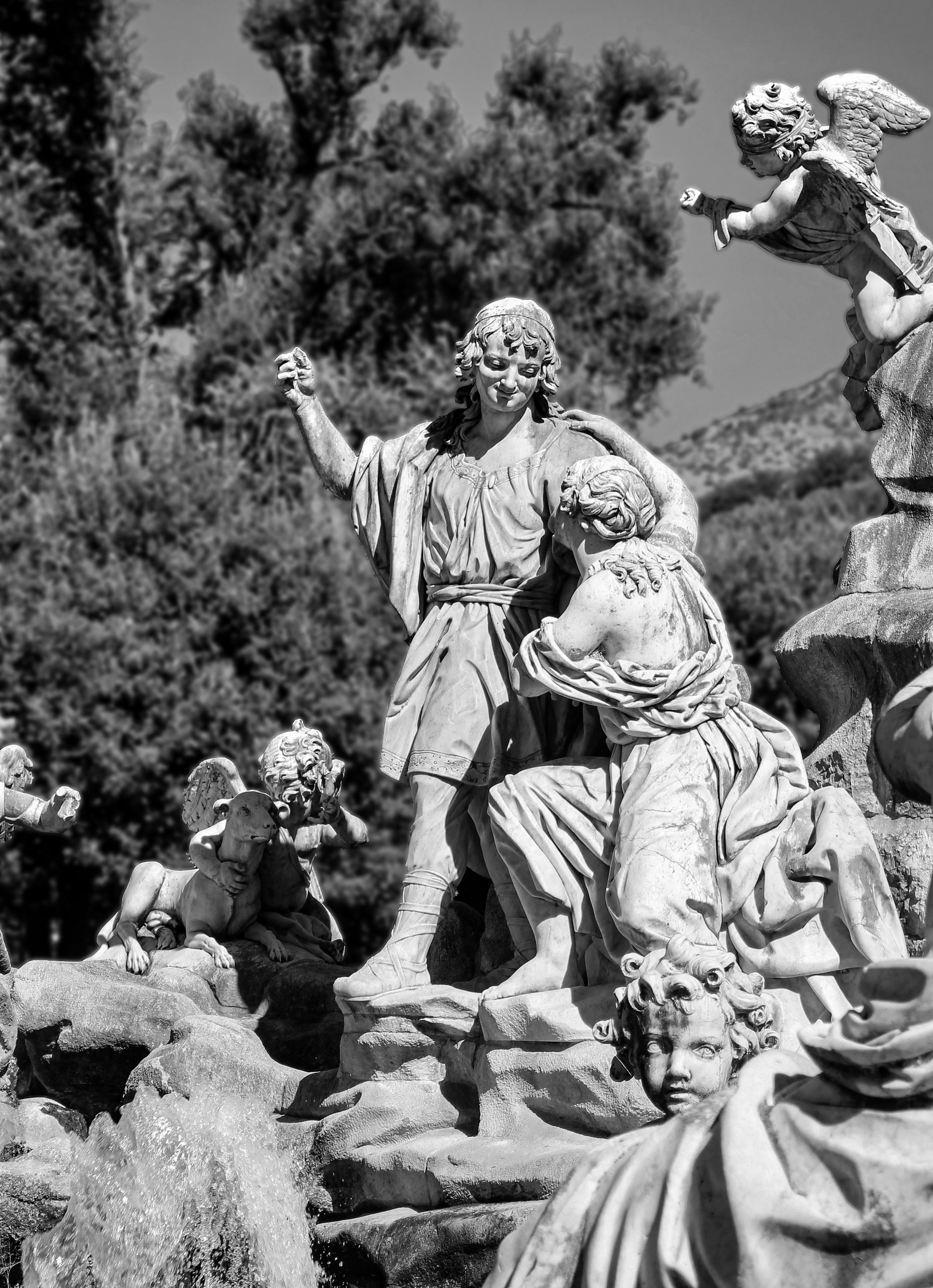 Artistic black and white photo featuring marble sculptures at the Royal Palace of Caserta, Italy.