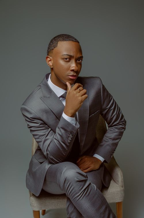 Free Elegant portrait of a confident Black man in a stylish suit, sitting in São Caetano do Sul, Brazil. Stock Photo