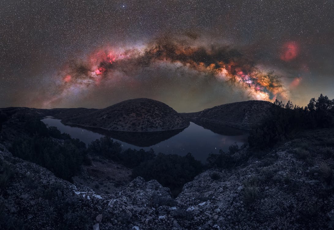 Milky Way on Night Sky over Hills and Lake