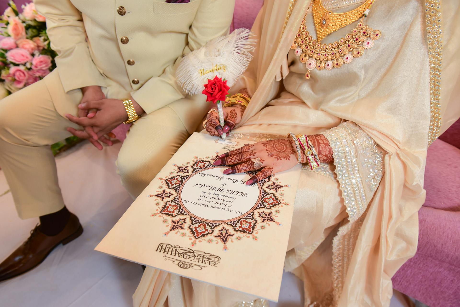Couple Holding and Signing Wedding Certificate During Ceremony