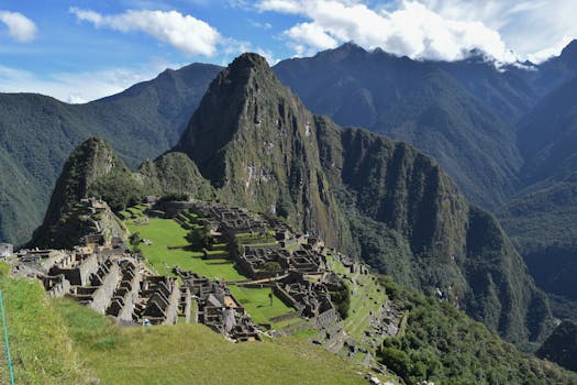 Explore the breathtaking architecture of Machu Picchu against majestic Andes mountains under a vibrant sky.