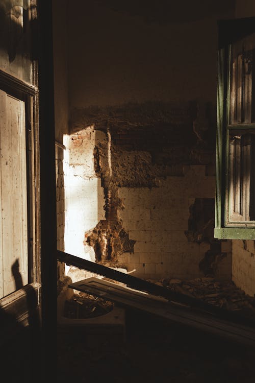 A window in an old building with a broken door