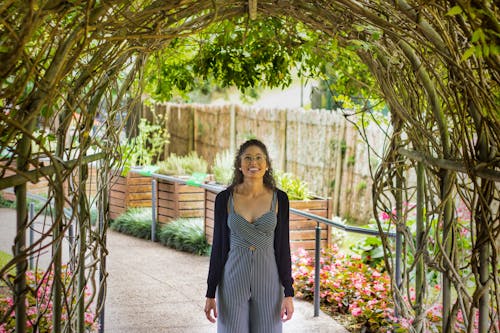 Woman Standing And Smiling On Pathway