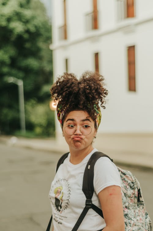 Free Photo of Woman in White T-shirt Carrying Backpack Stock Photo