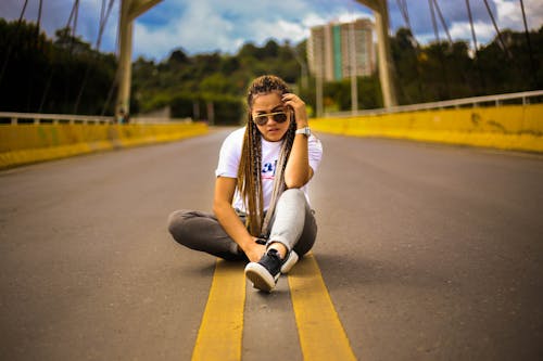 Photo of Woman Sitting In The Middle of the Road