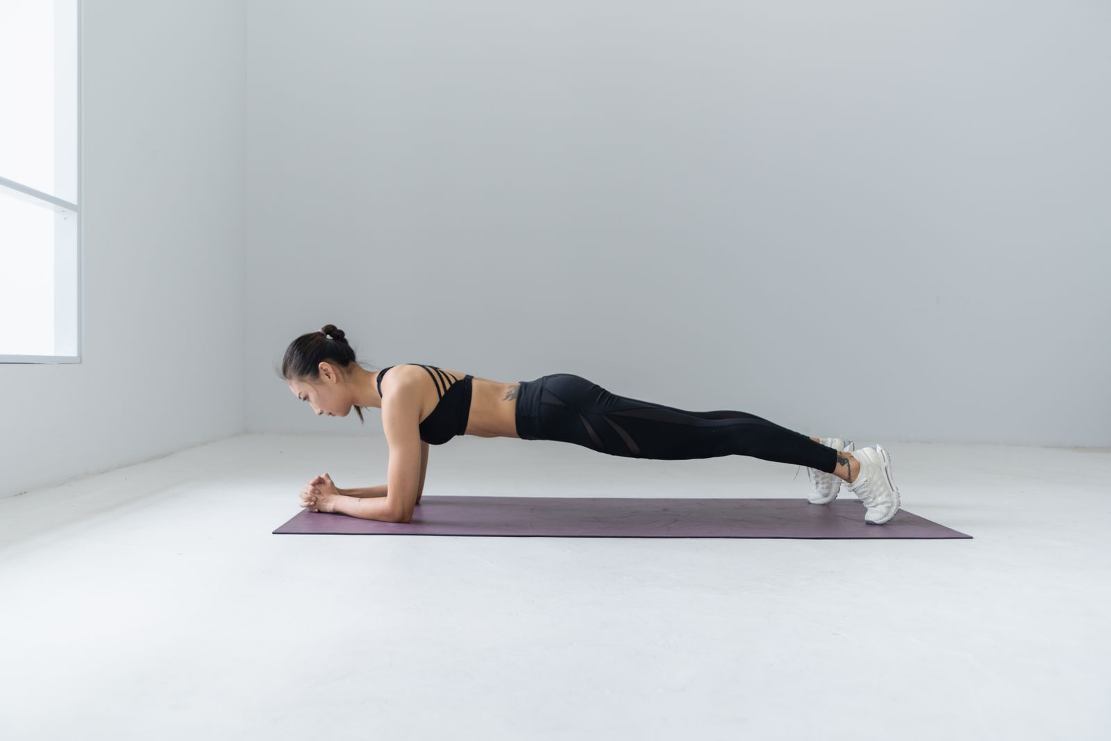 Person in outdoor yoga pose with mountains in background
