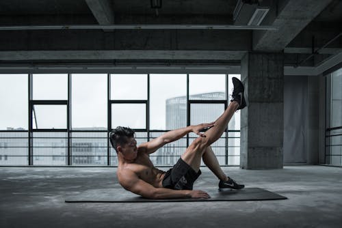 Free Photo of Topless Man Exercising on Yoga Mat Stock Photo