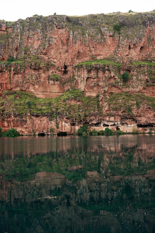 A cliff face with a body of water in the middle