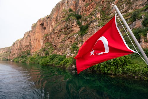 Turkish flag on a boat in the middle of a river