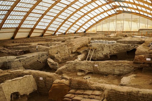 The ancient roman ruins are being excavated in the middle of a large building