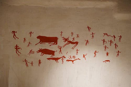 A cave painting depicting animals and people