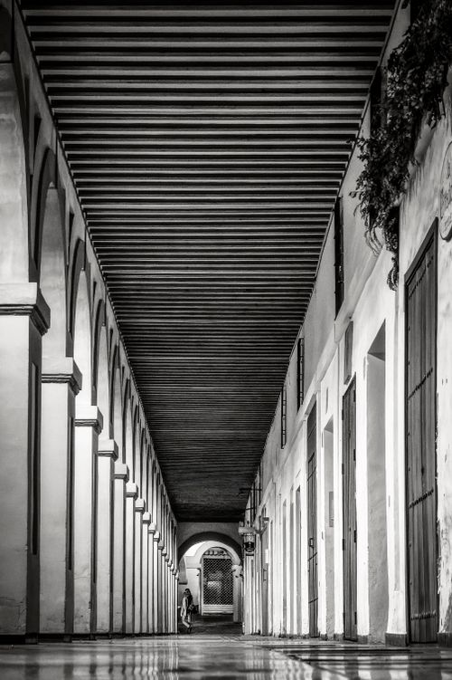 Free A black and white corridor with arches in Córdoba, Spain. Stock Photo