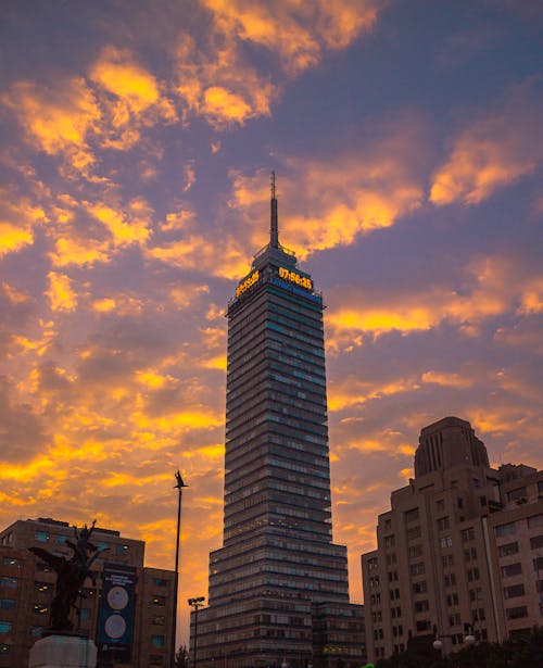 A tall building with a colorful sky behind it