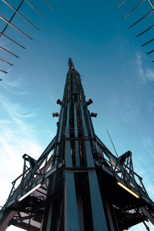 Free Dramatic view of Torre Latinoamericana's steel structure reaching into a clear blue sky in Mexico City. Stock Photo
