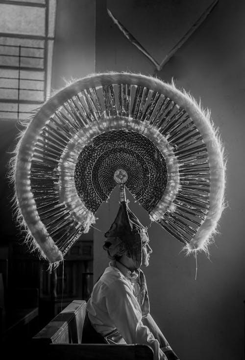 Man Sitting in Huge, Traditional Plume