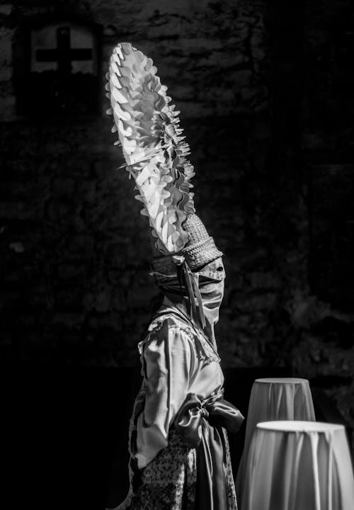 A black and white photo of a man in a costume