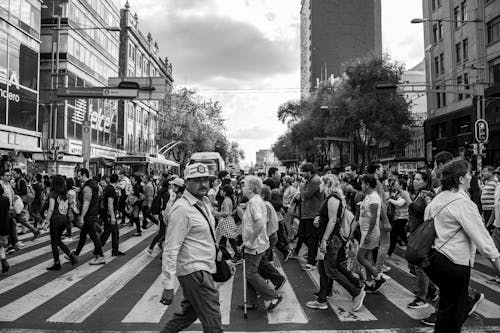 Black and white photo of people crossing a street