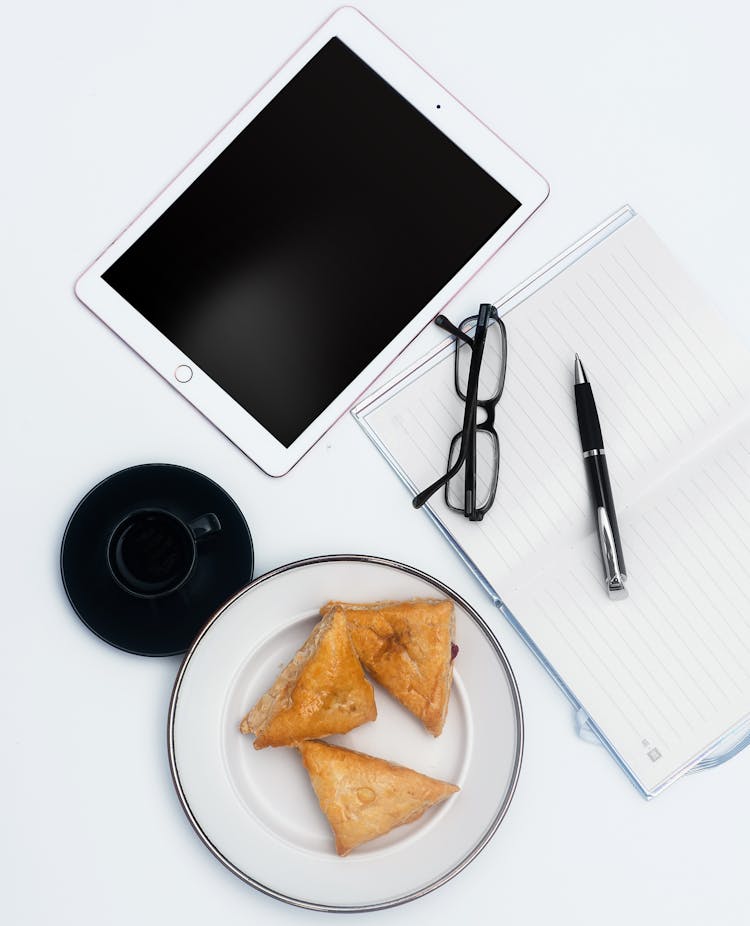 White Ipad And Items On White Surface