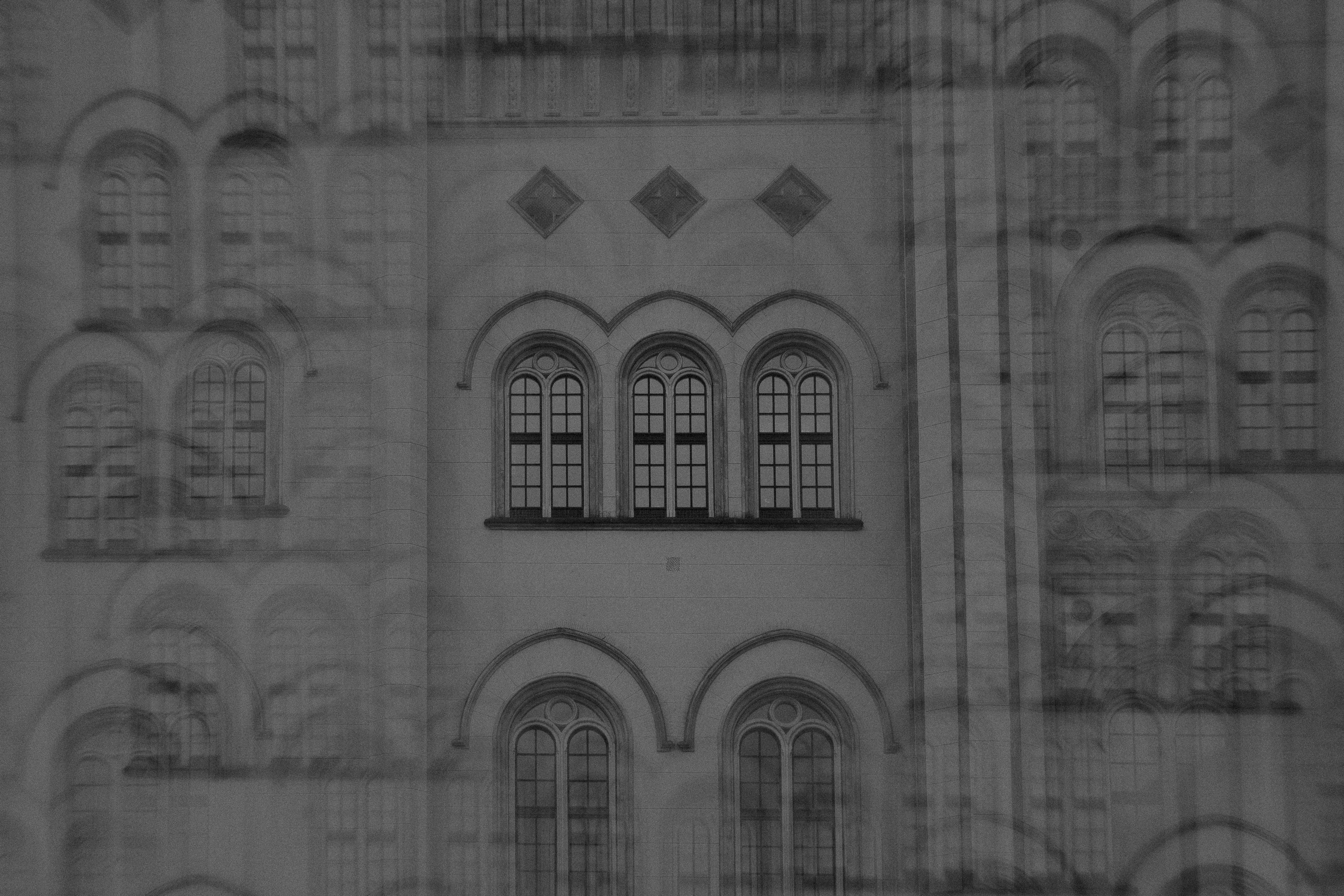 Black and white abstract view of historical building facade with arches and windows in Zittau, Germany.