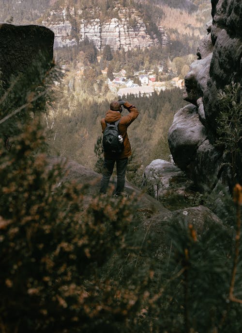 A person standing on a rock looking at the mountains