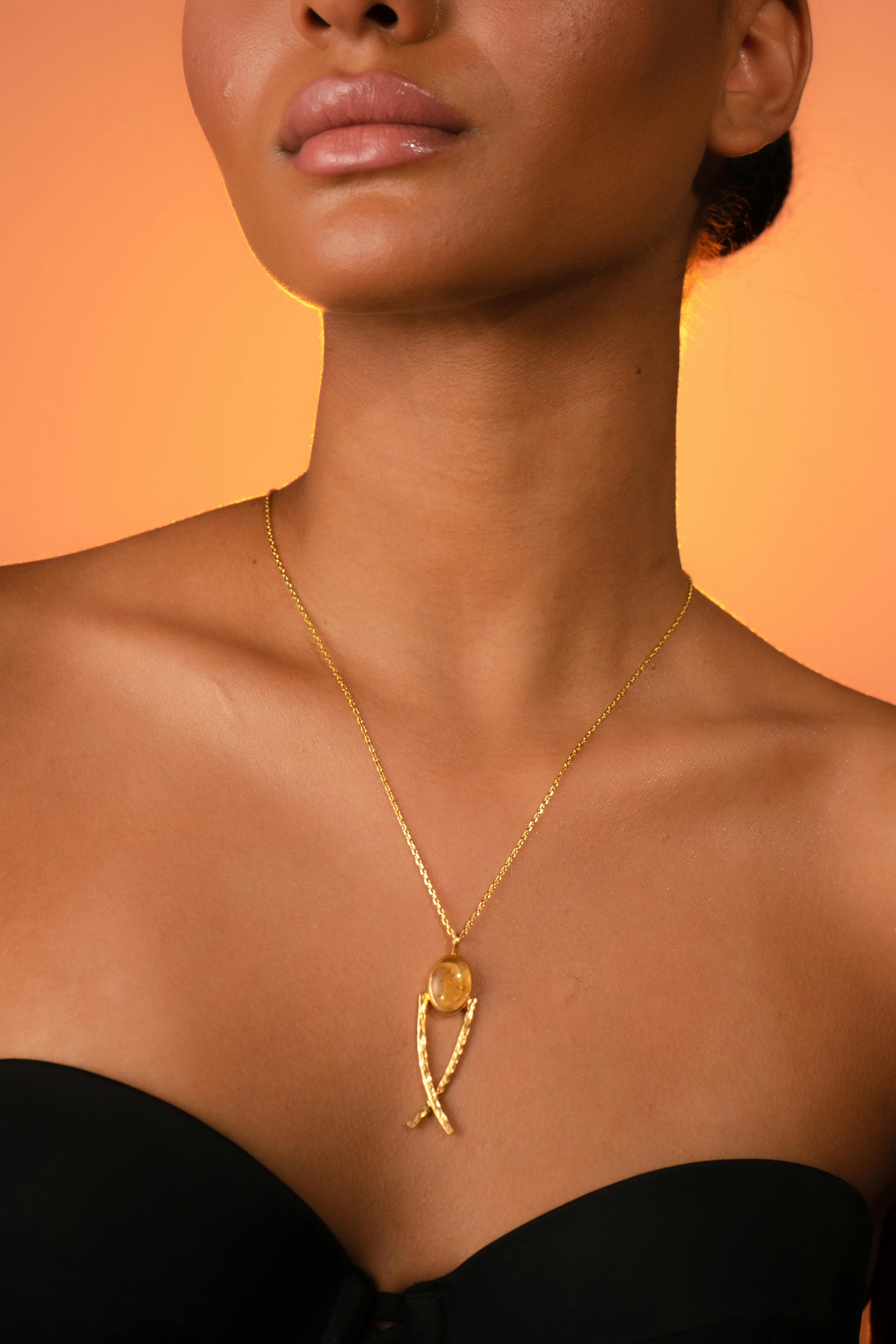 close up of woman with golden necklace