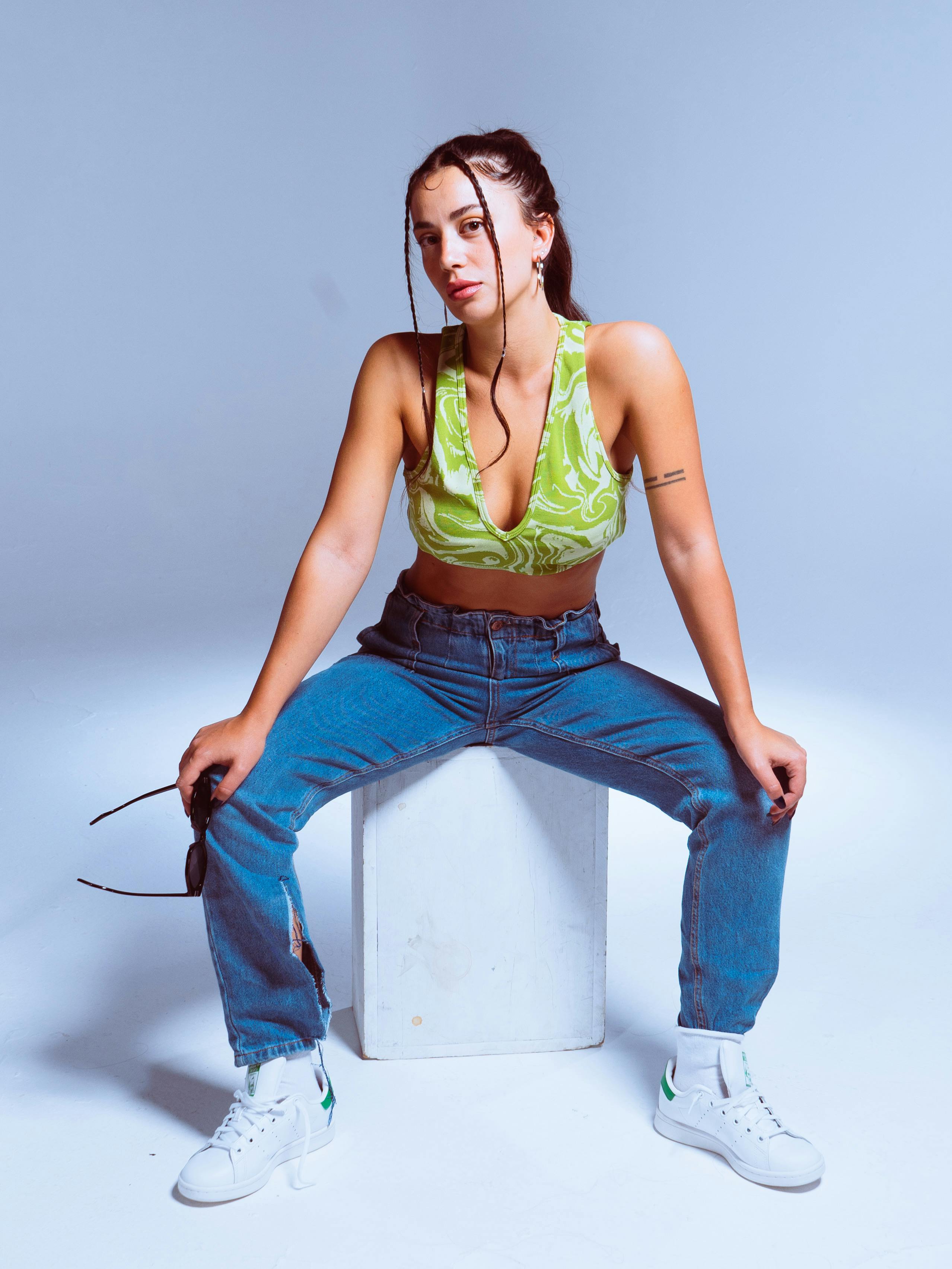 sitting woman in top and jeans