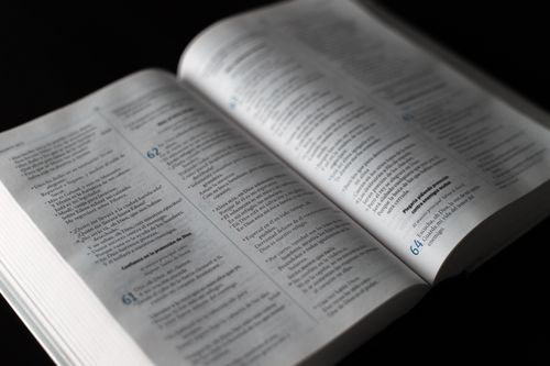 Free Close-up of an open religious text with highlighted passage, ideal for themes of faith and spirituality. Stock Photo