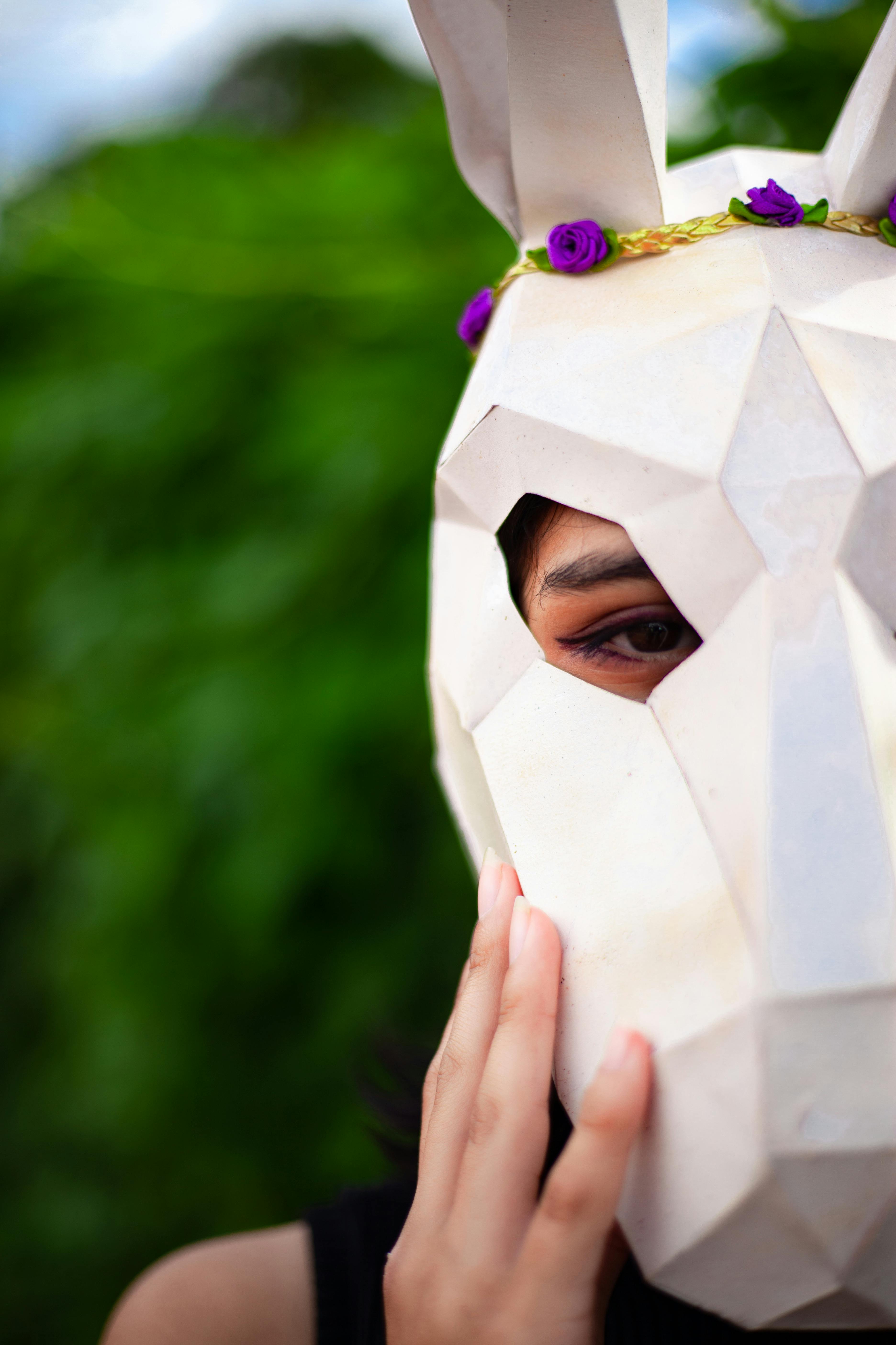 close up photo of wearing white horse paper mask