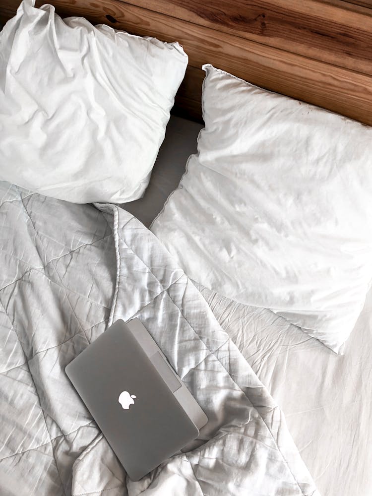 Macbook On A Messy Bed