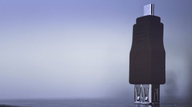 Detailed shot of a USB connector with a minimalist and modern aesthetic, emphasizing technology.